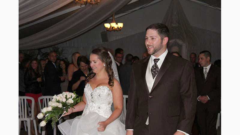 From Wedding 5, Oshawa DJ, Close up of Bride and Groom walking down the aisle after ceremony, guests in background. Taken in Oshawa Ontario